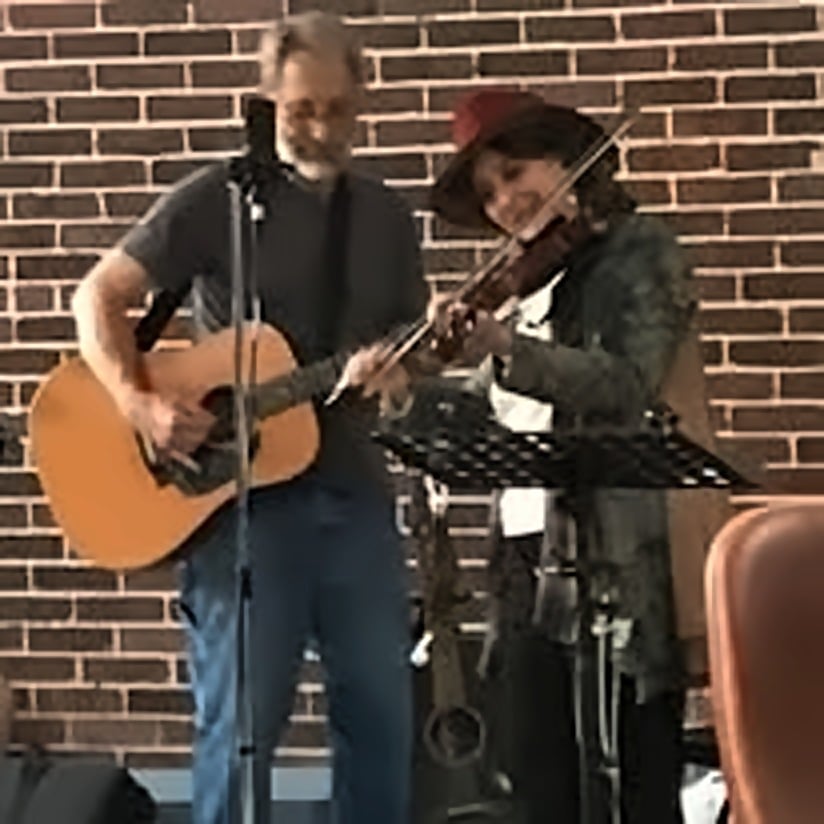 Snaggy Mountain Slackards performing with acoustic guitar and fiddle