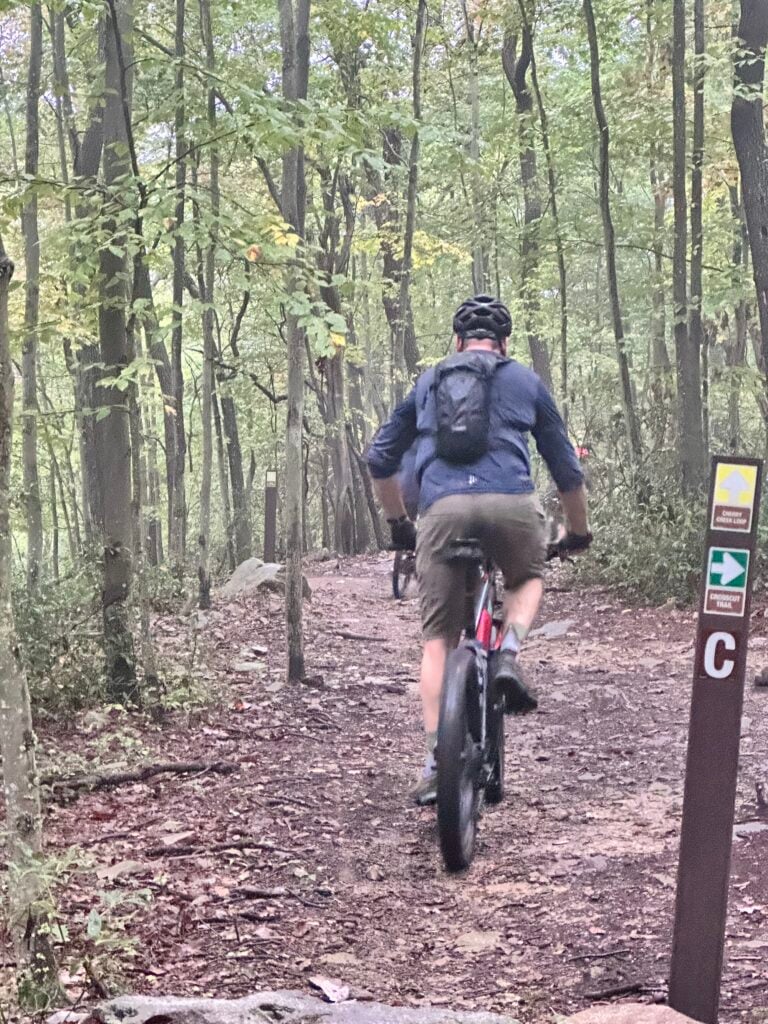 Rider passing a Cherry Creek trail marker