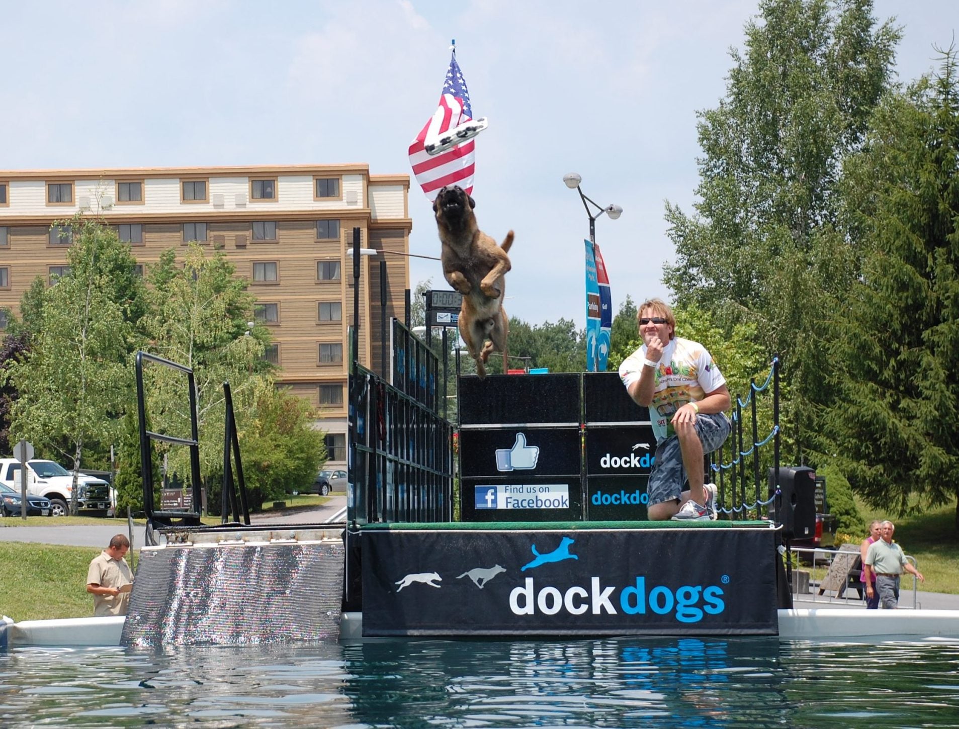 A dog leaps from the dock during a DockDogs competition at Wisp Resort